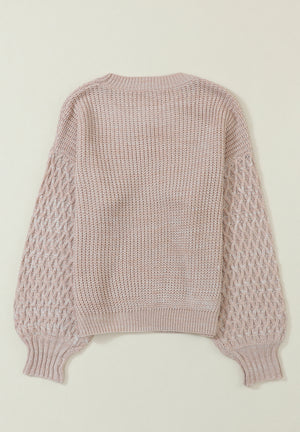 Tan textured knit sweater with diamond pattern sleeves and crew neck.