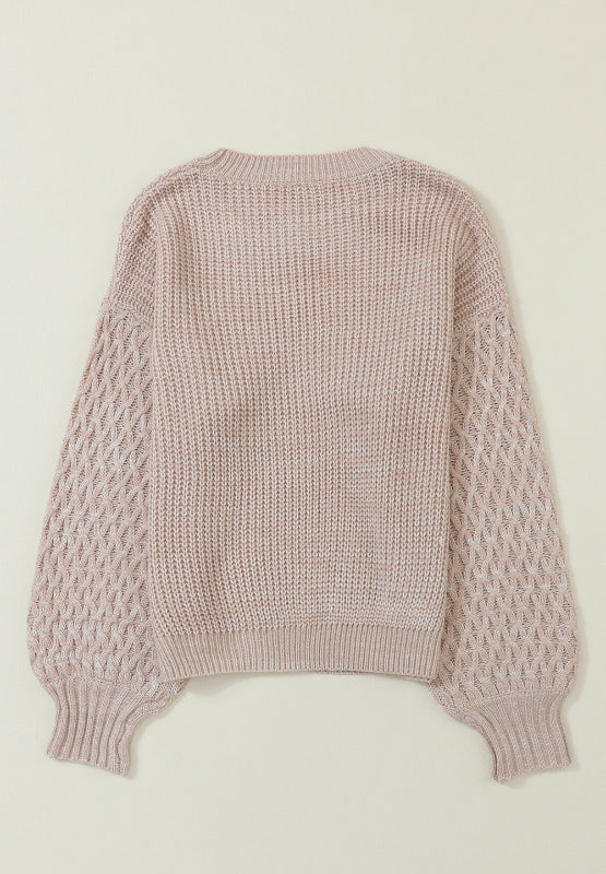 Tan textured knit sweater with diamond pattern sleeves and crew neck.