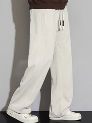 Men's apricot casual loose fit sweatpants with drawstring waist and wide leg.