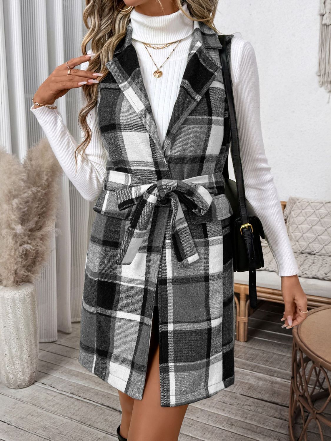 Plaid longline vest in dark gray with a belted waist and notched lapels.