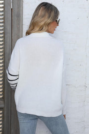 White collared knit sweater with black stripe detail on sleeves.