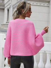Pink ribbed dolman knit sweater with boat neck and wide sleeves.