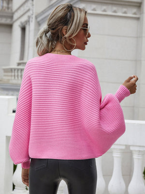 Pink ribbed dolman knit sweater with boat neck and wide sleeves.