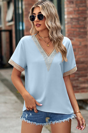 Light blue V-neck blouse with lace trim on neckline and sleeves.