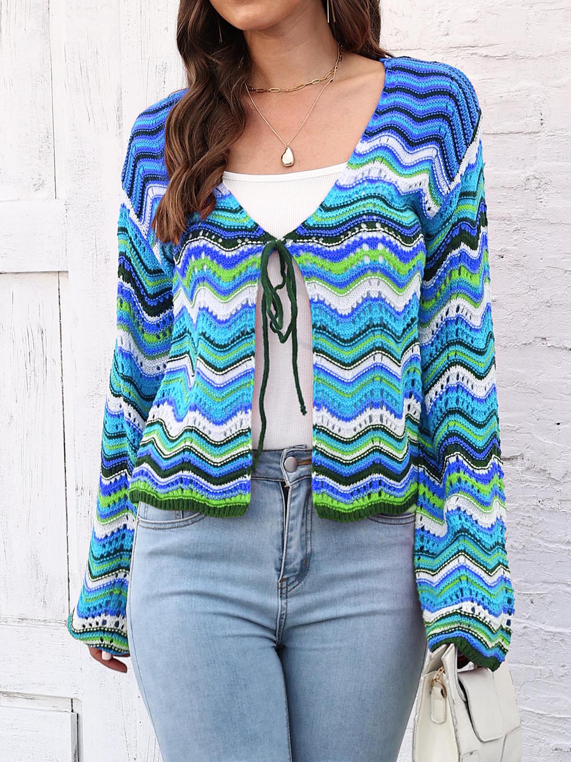 Chevron knit tie-front cardigan in blue and green with white accents, featuring a V-neck and long sleeves.