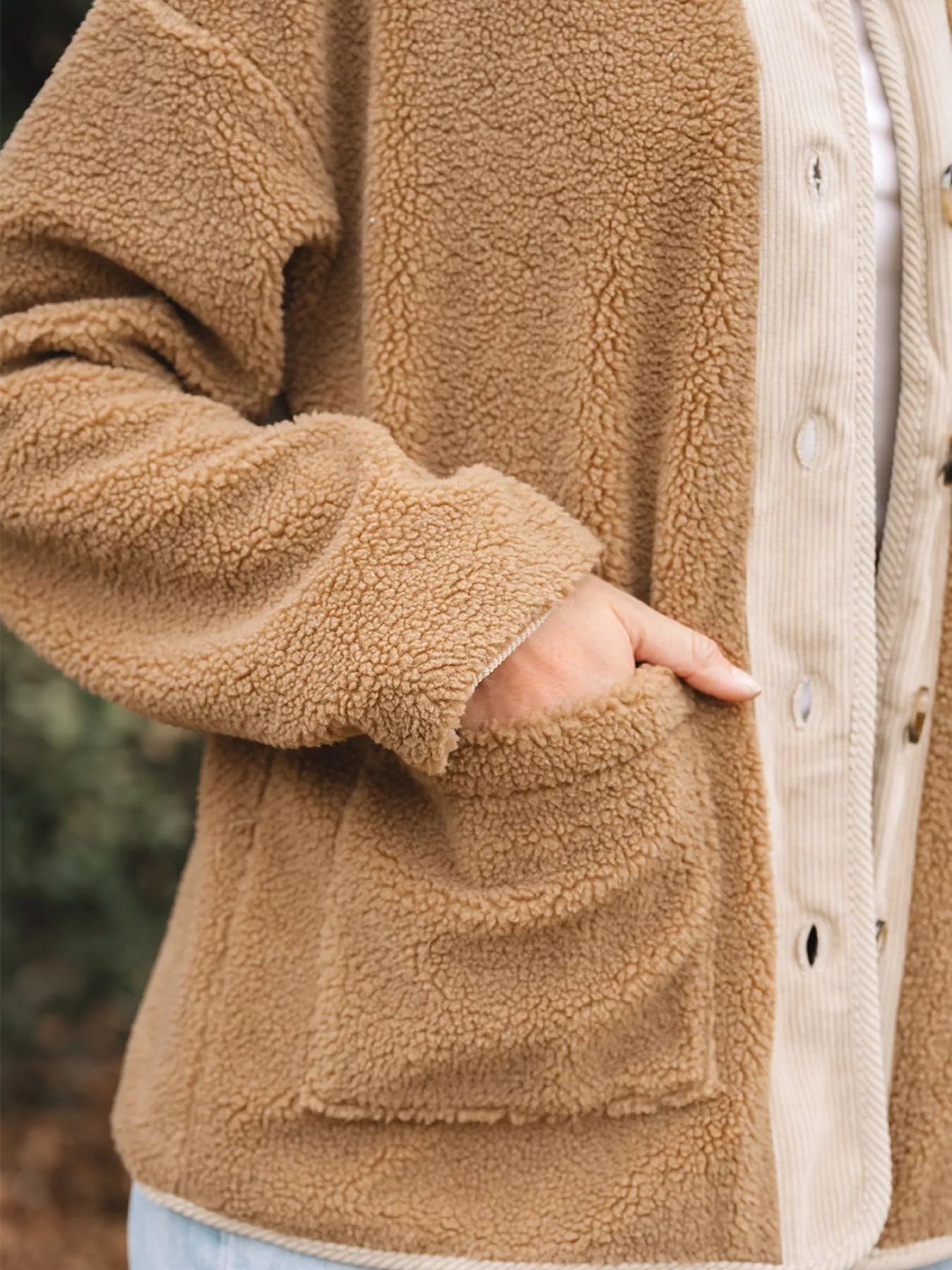 Plush corduroy patchwork jacket in camel with button front and patch pocket detail.