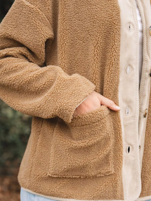 Plush corduroy patchwork jacket in camel with button front and patch pocket detail.