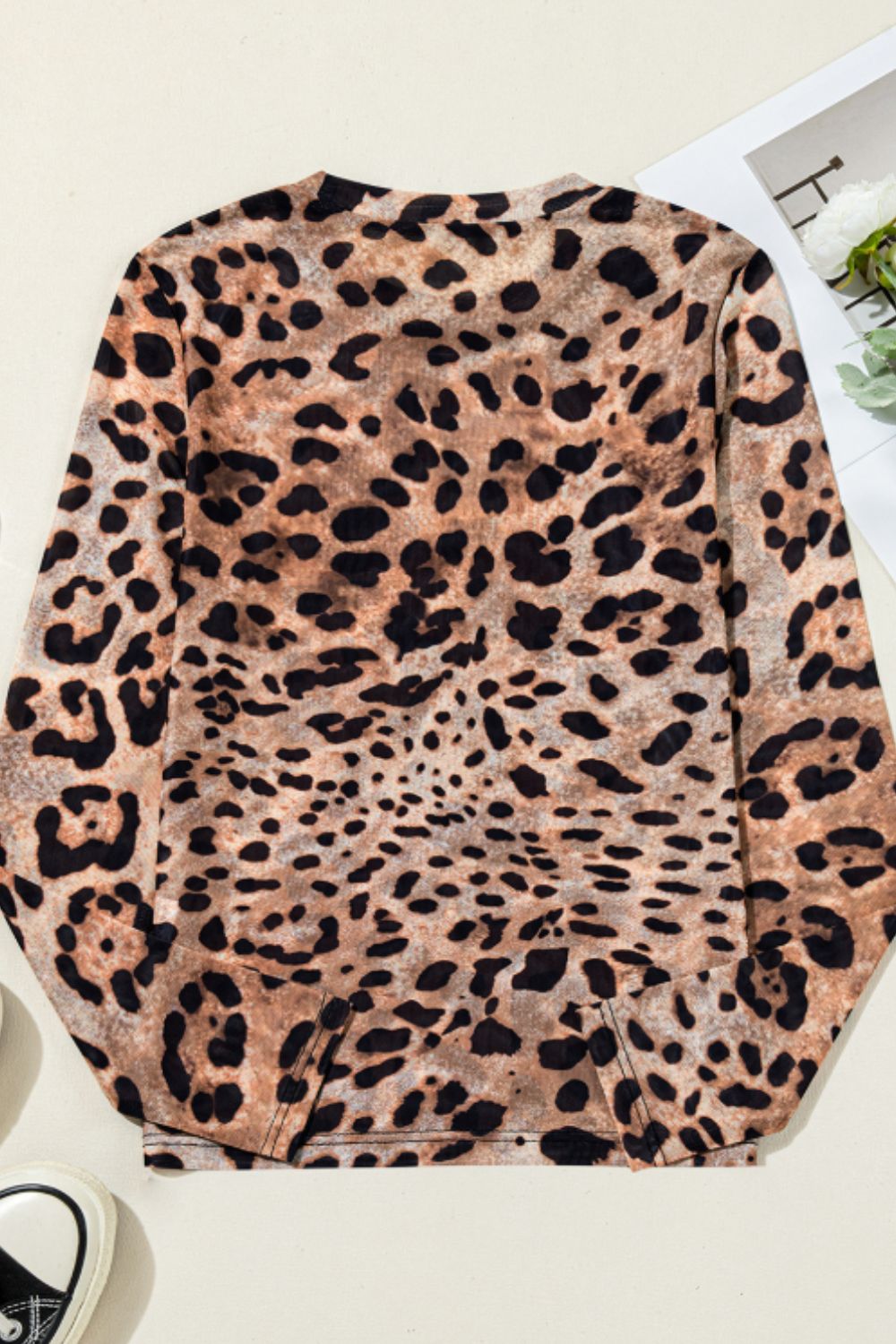 Sheer leopard print long sleeve blouse with a crew neck.