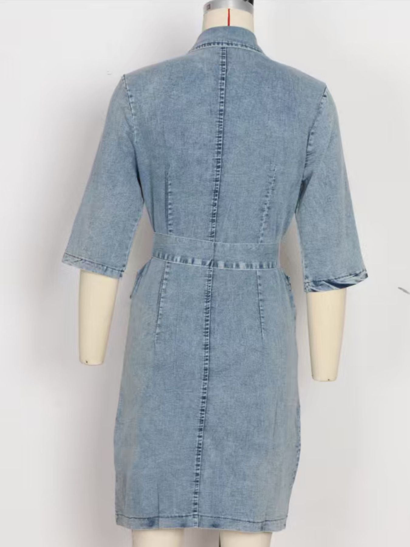 Light blue denim shirt dress with 3/4 sleeves and a belted waist.