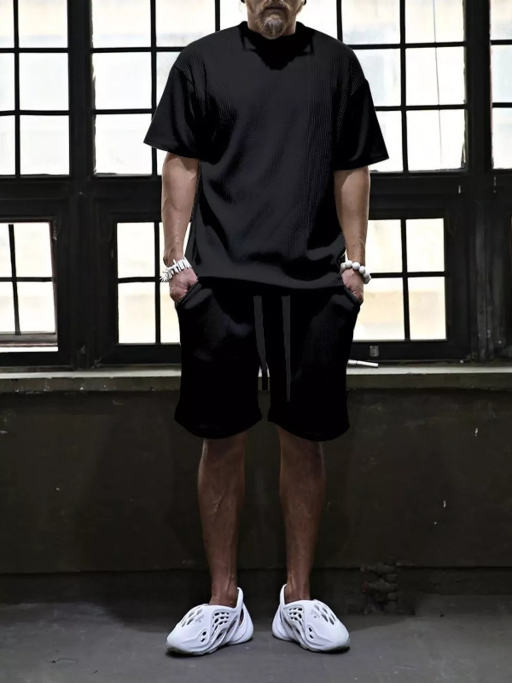 Black ribbed t-shirt and drawstring shorts set for men, casual comfort style.