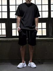 Black ribbed t-shirt and drawstring shorts set for men, casual comfort style.