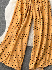 Yellow polka dot smocked wide-leg romper with flowing legs