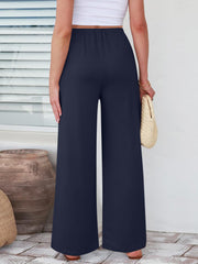 Pleated palazzo trousers in dark blue with a wide leg and pockets.