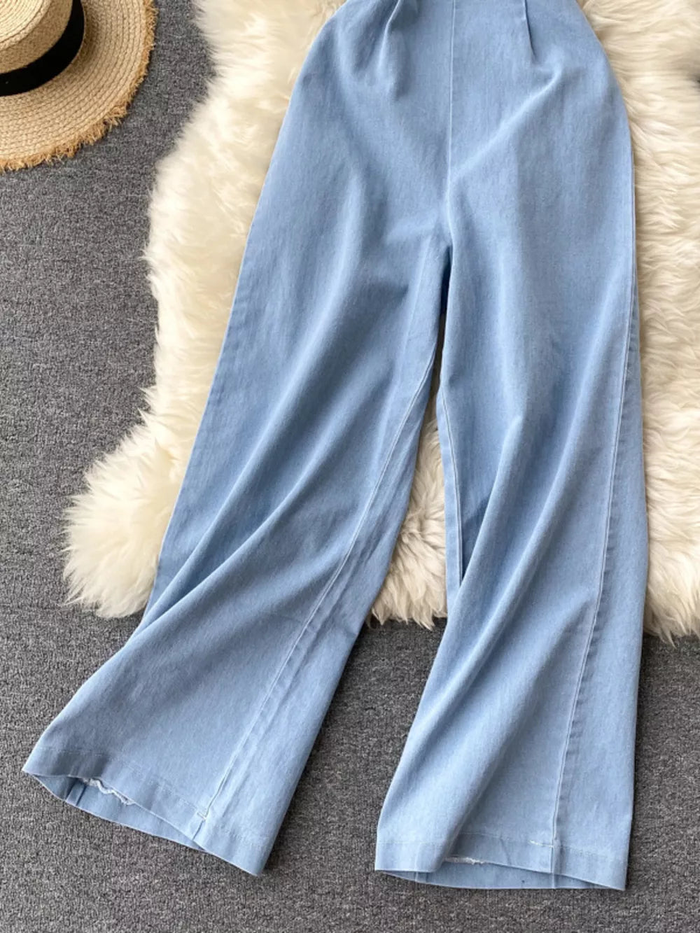 Light blue denim wide-leg jumpsuit with frayed hem detail