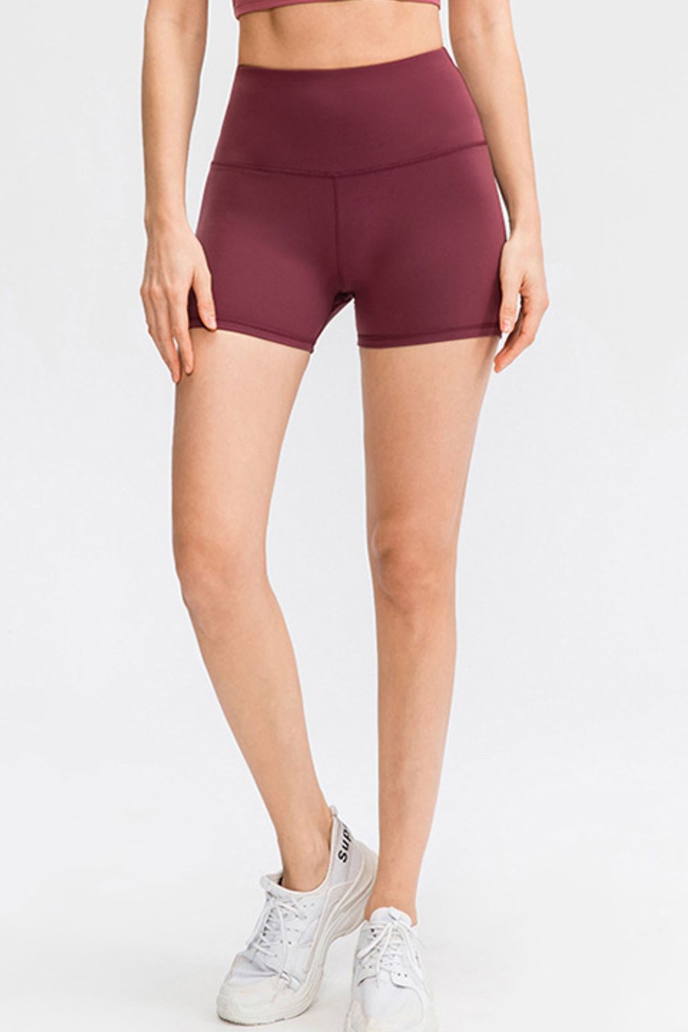 Burgundy athletic shorts with a high waist and sculpted fit.