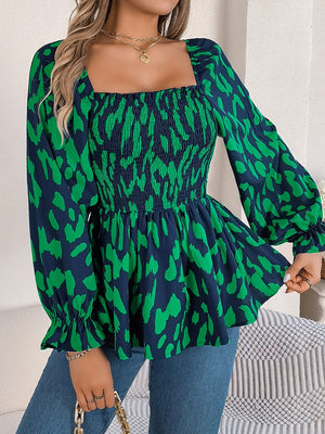 Smocked bodice square neck blouse with green and navy abstract print and balloon sleeves.