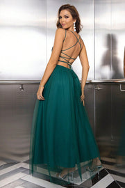 Green sequin bodice tulle maxi dress with backless crisscross straps and flowing skirt.