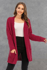 Burgundy textured cocoon cardigan with patch pockets and open front.