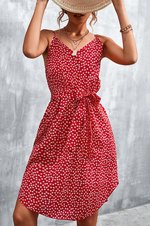 Red daisy print slip dress with tie waist and V-neckline.