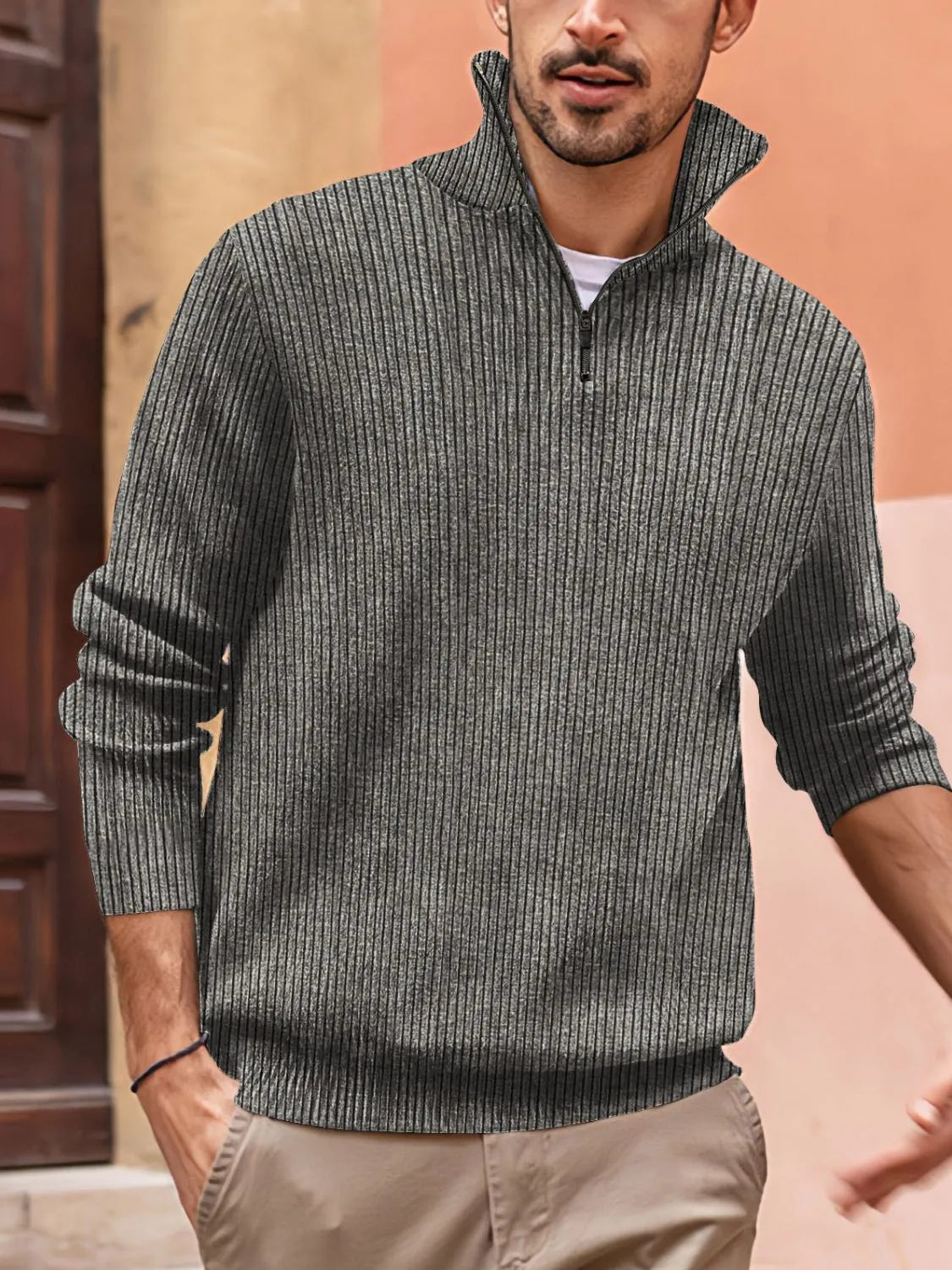 Textured ribbed quarter-zip pullover in gray with a tall collar and zipper detail.