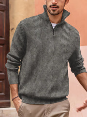 Textured ribbed quarter-zip pullover in gray with a tall collar and zipper detail.