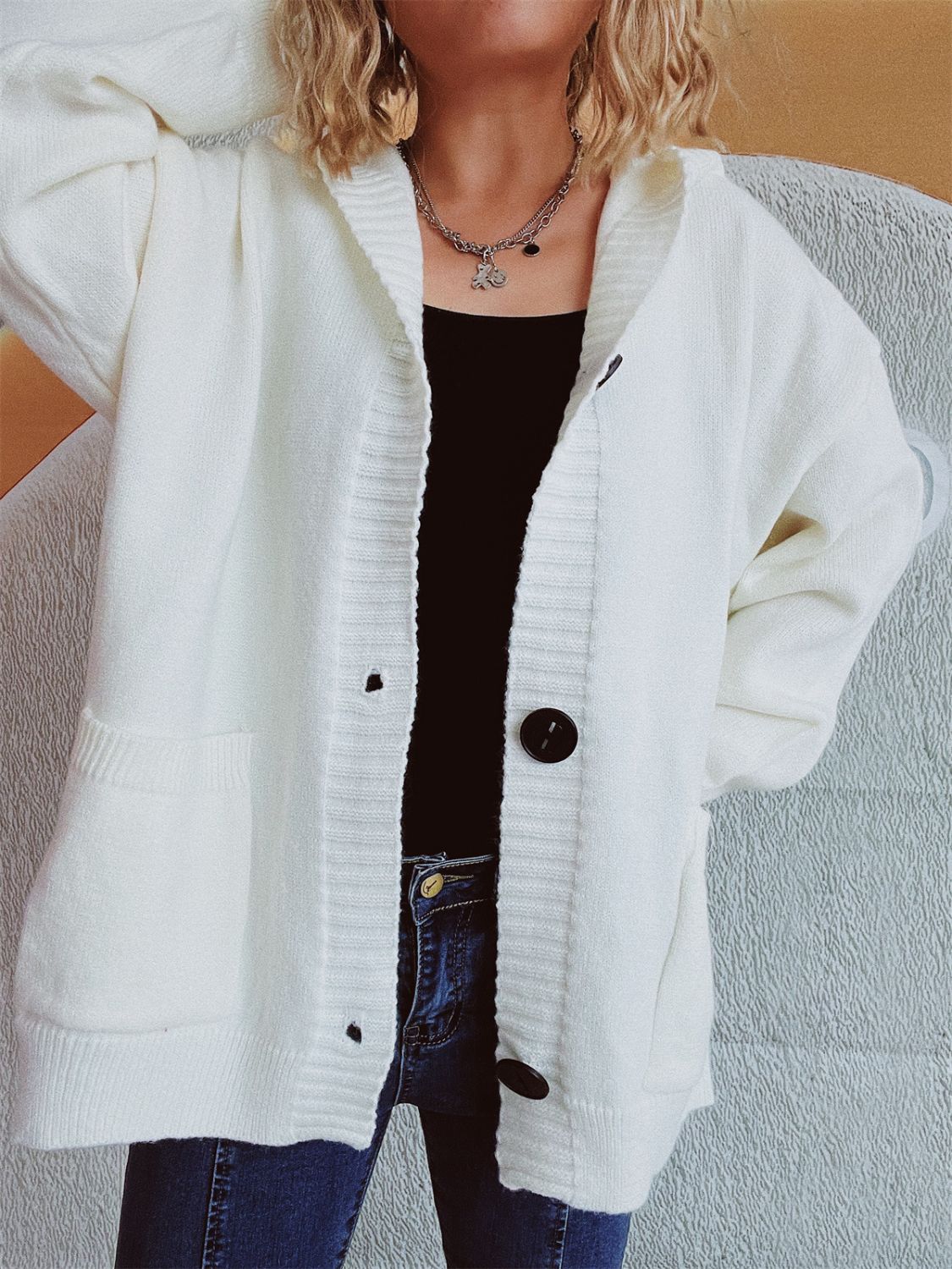 White chunky knit hooded cardigan with button-down front and pockets