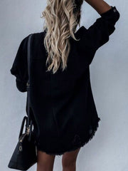 Black denim shirtdress with distressed details and raw hem, collared, long sleeves.