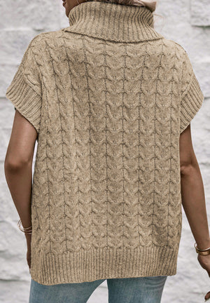 Khaki cable knit turtleneck capelet sweater with short sleeves and ribbed trim.