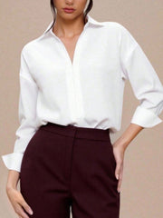 Classic collared long sleeve white bodysuit with button-down front and cuffed sleeves.
