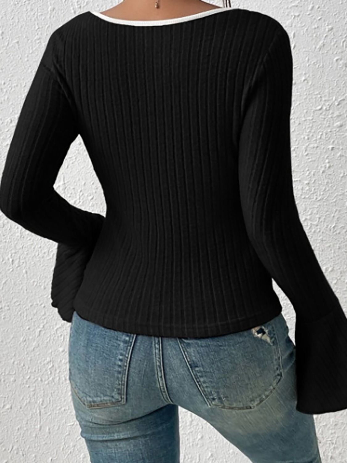 Black ribbed flare sleeve top with contrast trim neckline.