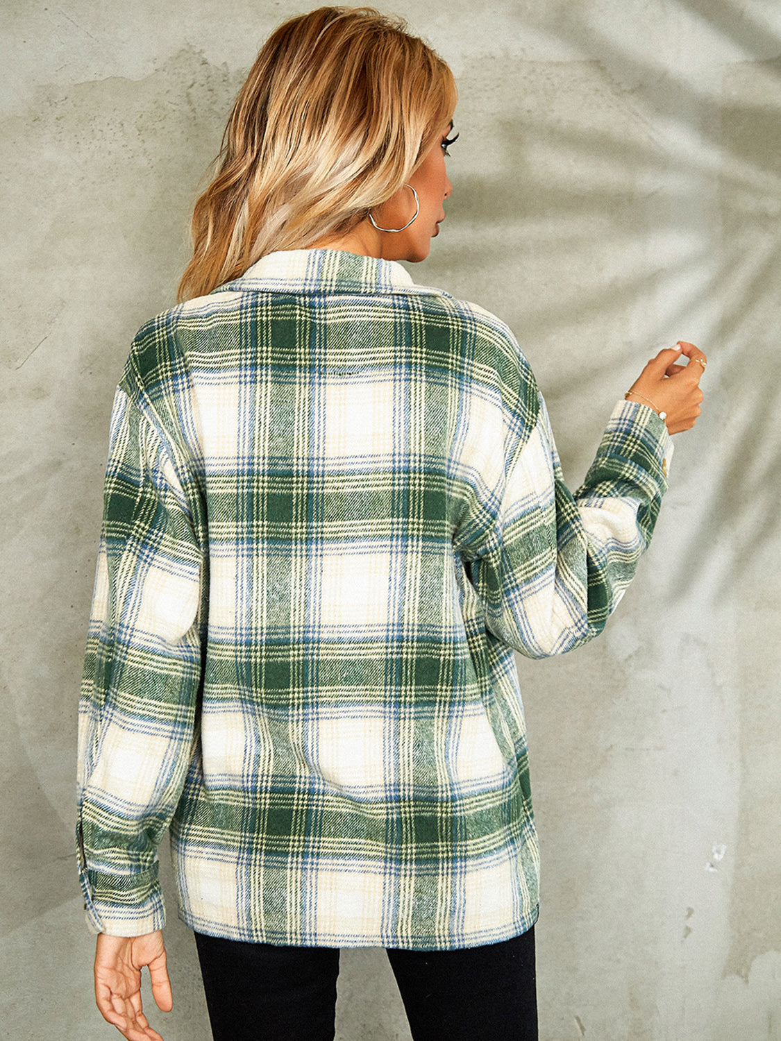 Collared jacket with green, blue, and cream plaid pattern, button front, and long sleeves.