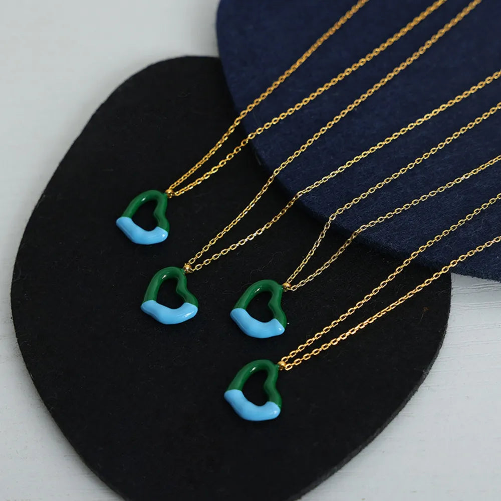 Two-tone heart enamel necklace with gold chain, green and blue detail