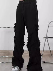 Black wide-leg jeans for men with fringe trim detail on the legs.