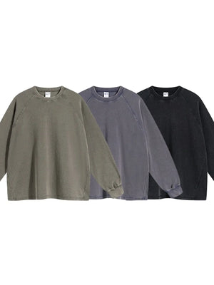 Raglan sleeve washed cotton sweatshirt in olive, dark gray, and black with crew neck.