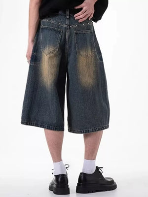 Relaxed fit dark blue denim shorts with distressed wash and pocket details.