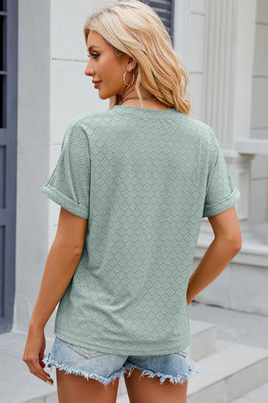 Light green textured henley tee with rolled sleeves and eyelet pattern