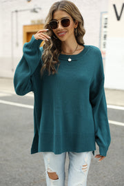 Turquoise knit pullover sweater with crew neck, long sleeves, and side slits.