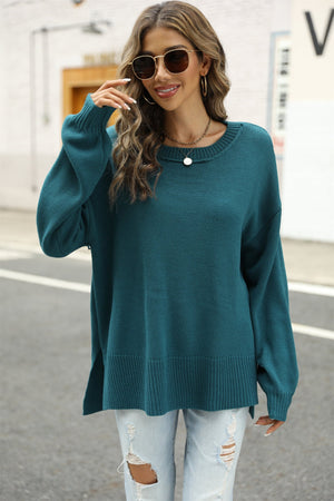 Turquoise knit pullover sweater with crew neck, long sleeves, and side slits.