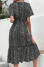 Black floral print midi dress with smocked waist and flutter sleeves.