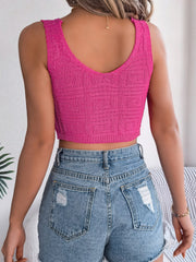Hot pink knit crop top with a textured geometric pattern and a V-neck.