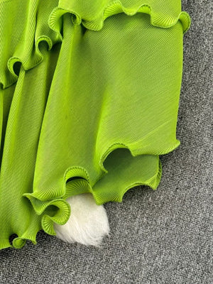 Lime green pleated midi dress with ruffled tiers and a belted waist detail.