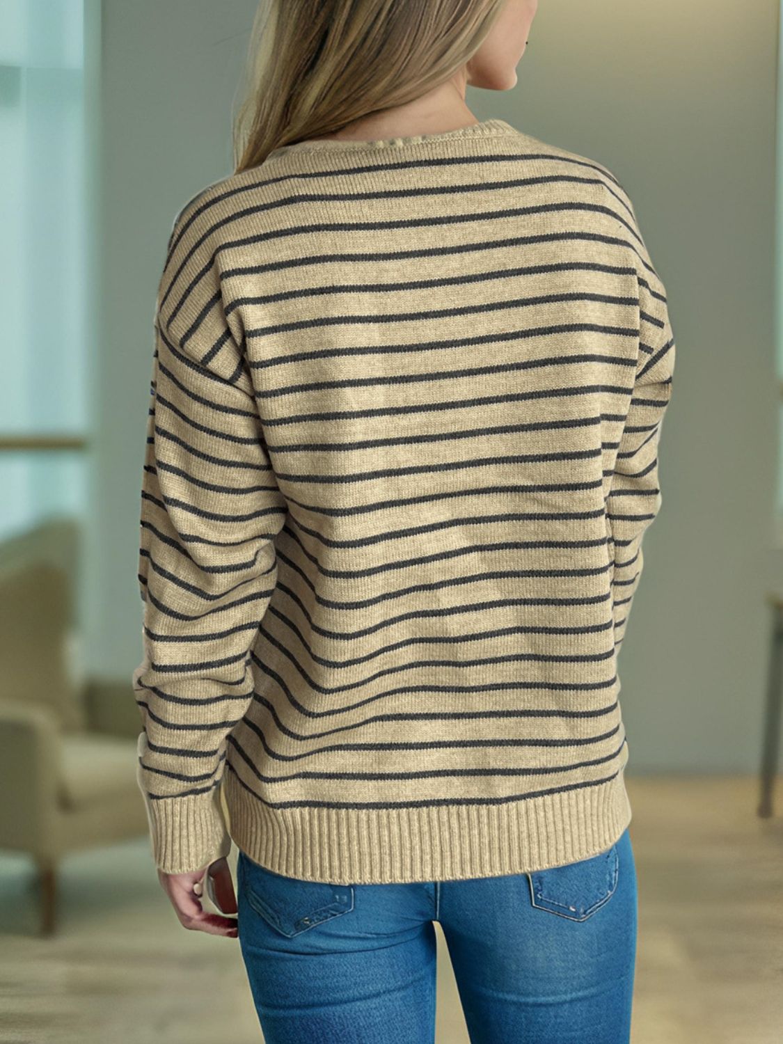 Tan and black striped knit sweater with a crew neck and ribbed cuffs and hem.