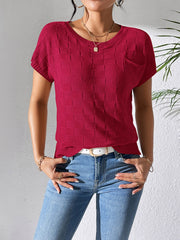 Burgundy knit pocket tee with a textured check pattern and short sleeves.