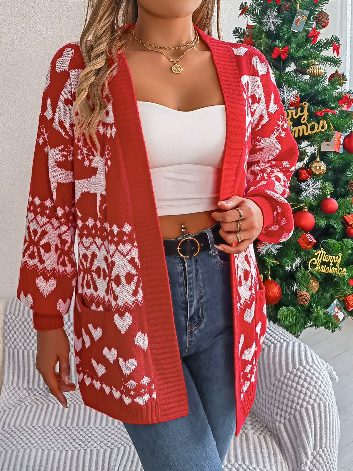 Festive red open-front cardigan with white reindeer and heart jacquard pattern, acrylic knit, long sleeves, and pockets.