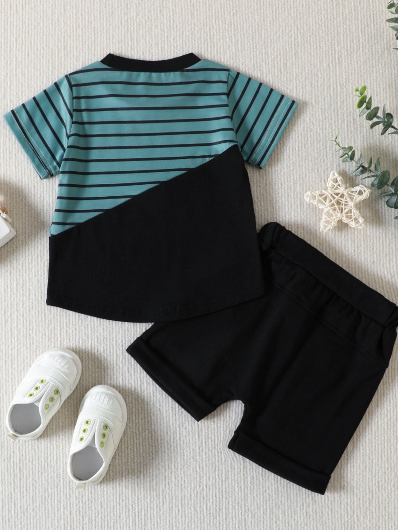 Striped baby t-shirt with black color block and matching black shorts.