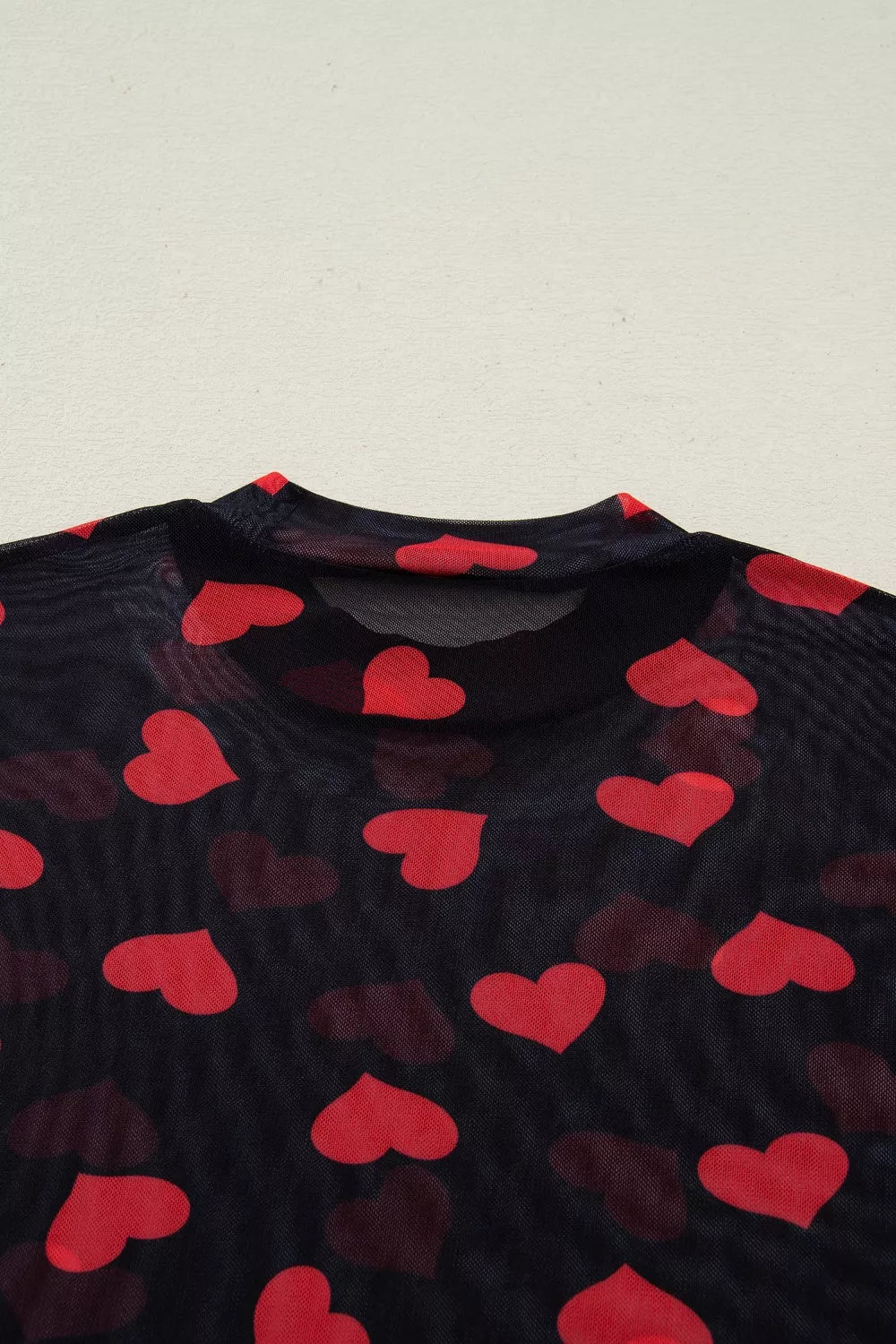 Black sheer mesh top with red heart print and mock neck