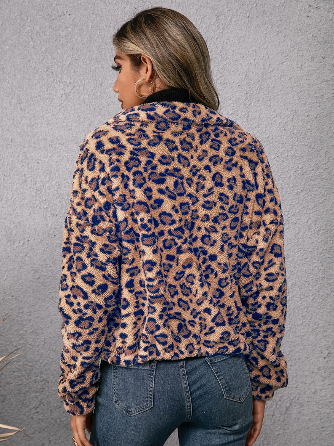 Leopard sherpa bomber jacket with a zip-up front and plush texture.