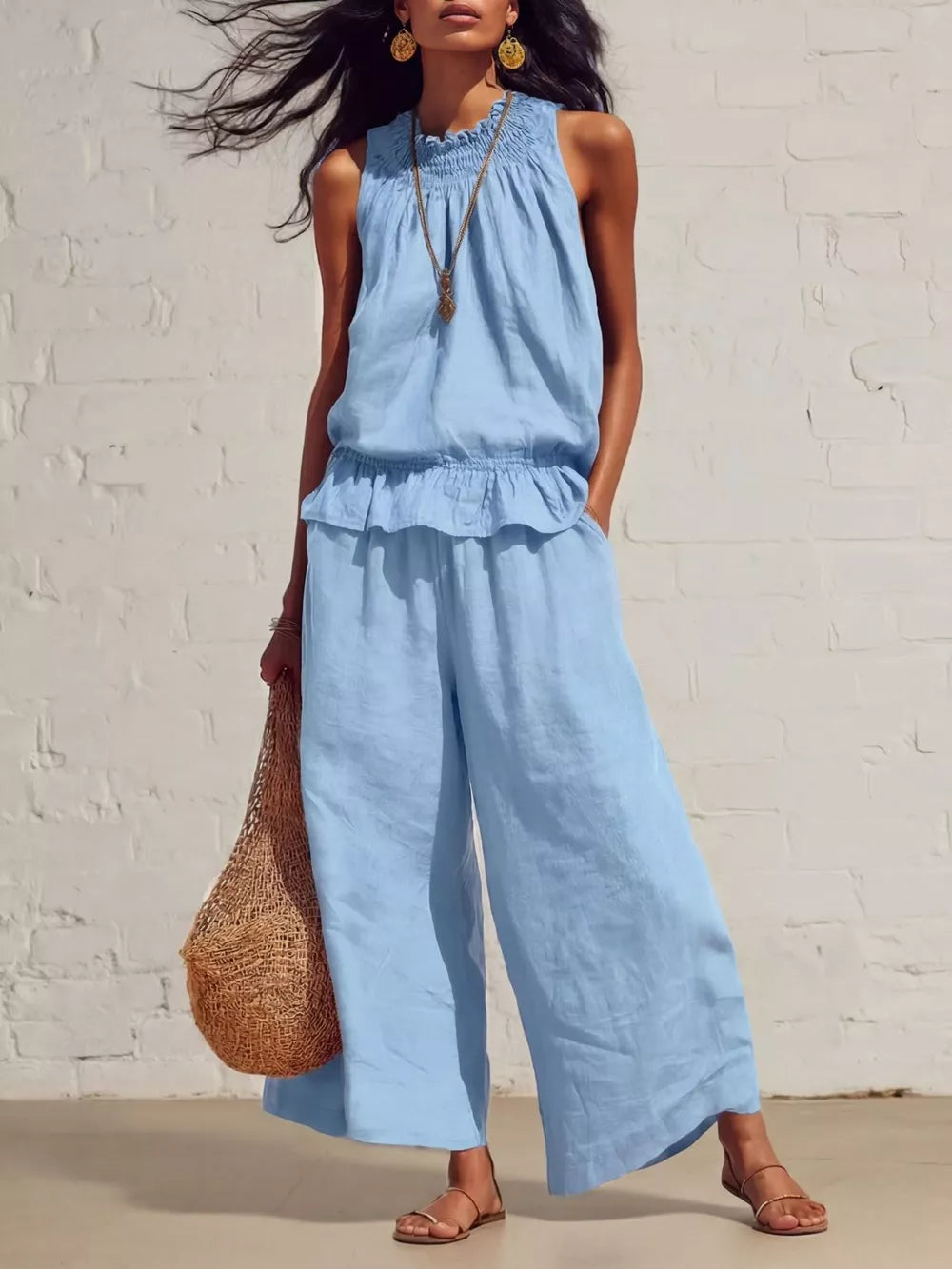 Sky blue smocked peplum top and flowing pants set with ruffled hem and elastic waist.