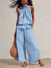 Sky blue smocked peplum top and flowing pants set with ruffled hem and elastic waist.