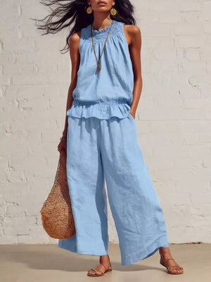 Sky blue smocked peplum top and flowing pants set with ruffled hem and elastic waist.
